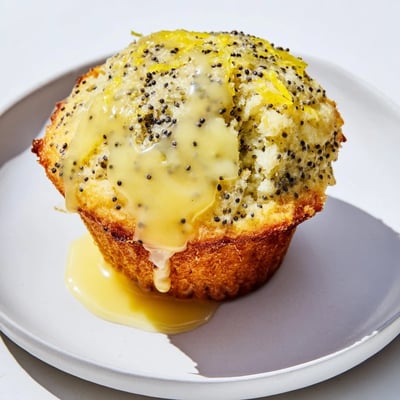 Freshly baked Lemon Poppy Seed Muffins, bursting with citrus flavor and ideal with coffee.