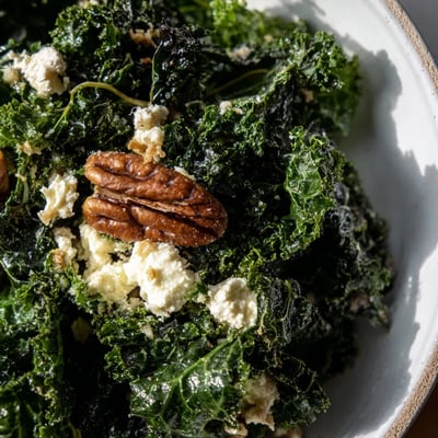 Freshly massaged kale in Winter Kale Salad glistens with tangy maple vinaigrette, topped with toasted pecans and creamy goat cheese crumbles.