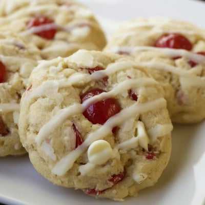 These soft Irresistible Maraschino Cherry Cookies have a shiny almond glaze and bright red cherry pieces visible.
