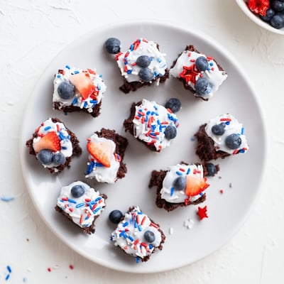 Bite-sized Fourth of July brownie bites drizzled with sweet glaze and colorful decorations.  