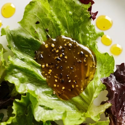 Creamy honey vinaigrette in a glass jar, ready to serve.  
